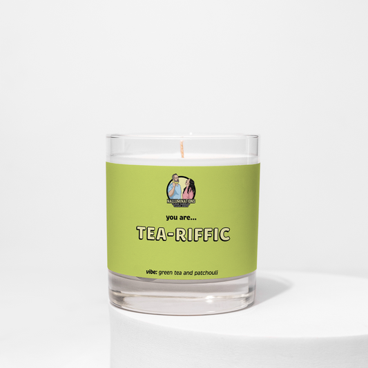 8oz coconut soy candle in a clear glass jar with a bright lime green label that reads “You are… Tea-Riffic.” The scent vibe is green tea and patchouli. The candle is unlit and placed against a white background.