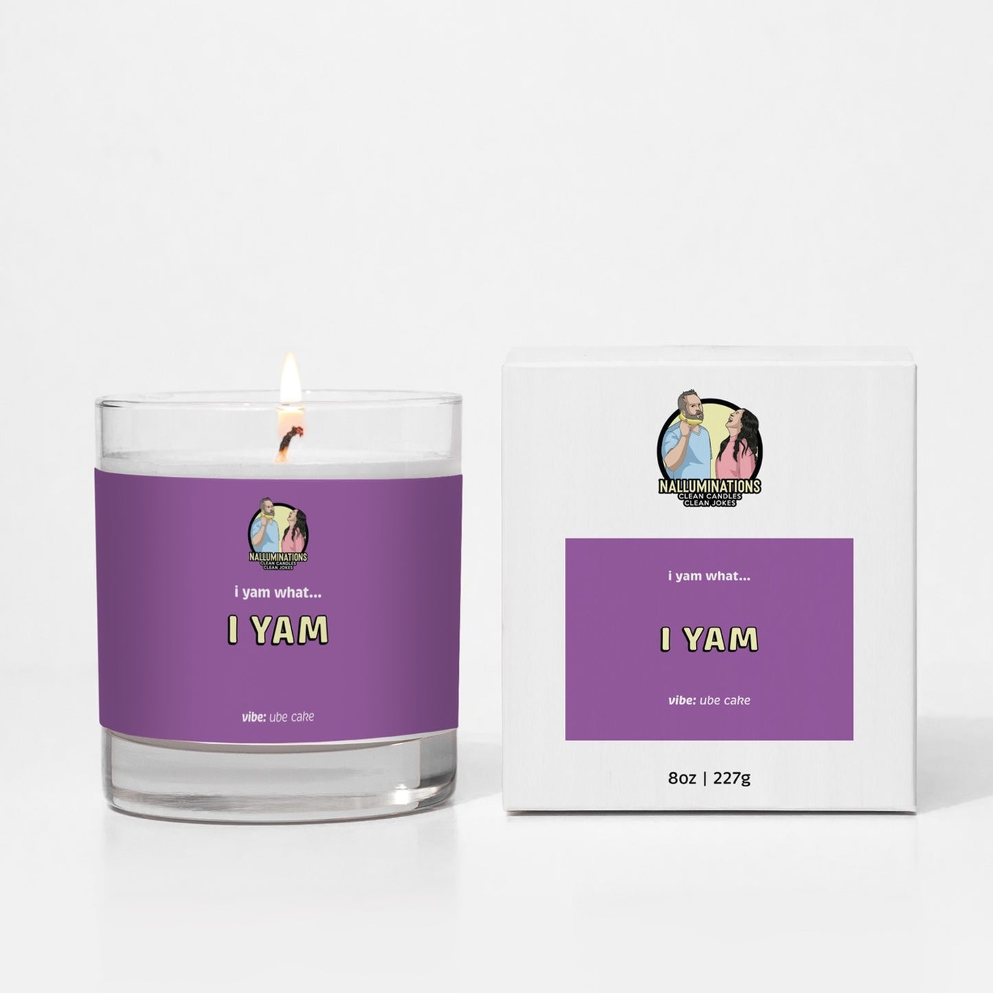 Coconut soy 8oz candle labeled “I Yam” in a bold purple design with ube cake scent, shown lit next to its matching box on a white background.