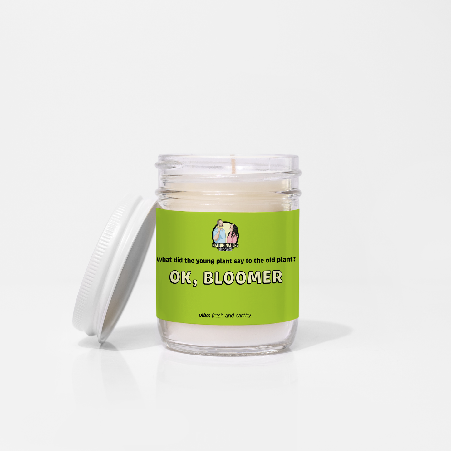 Ok, Bloomer – fresh earthy funny coconut soy candle with gardenia, sandalwood, and moss in 6.5oz clear glass jar with white lid and green label, photographed on white background.