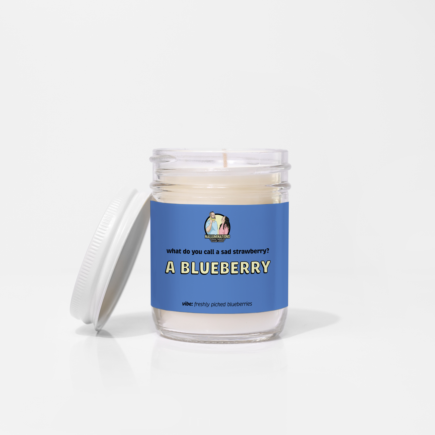 A Blueberry – blueberry scented funny coconut soy candle in 6.5oz clear glass jar with white lid and navy label, photographed on white background.