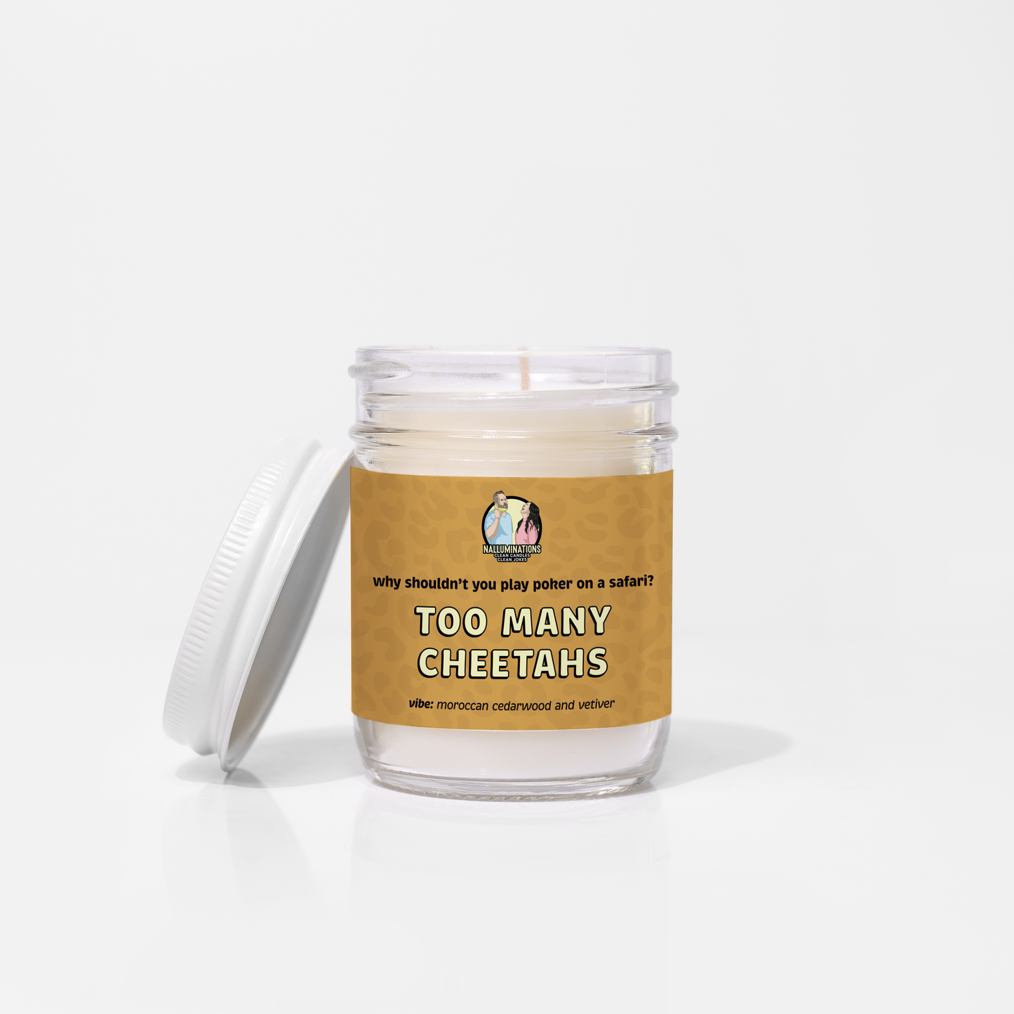 6.5oz coconut soy candle in a clear glass jar with a white lid and a cheetah-print brown label that reads “Why shouldn’t you play poker on a safari? Too Many Cheetahs.” Moroccan cedarwood and vetiver scent, displayed on a white background.