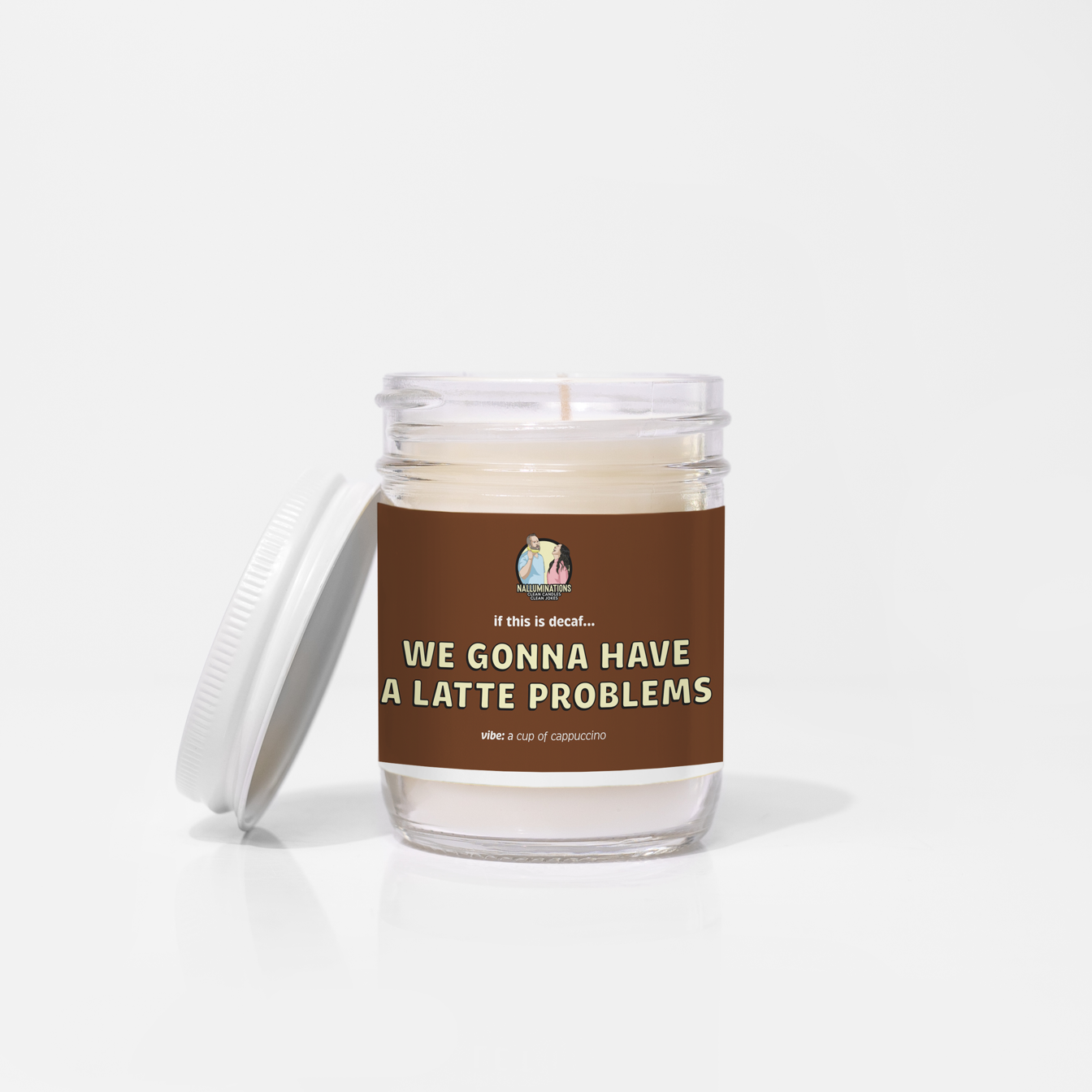 6.5oz coconut soy candle in a clear glass jar with a white lid. The brown label reads “If this is decaf… We Gonna Have a Latte Problems.” The scent vibe is a cup of cappuccino. The candle is unlit and placed against a white background.