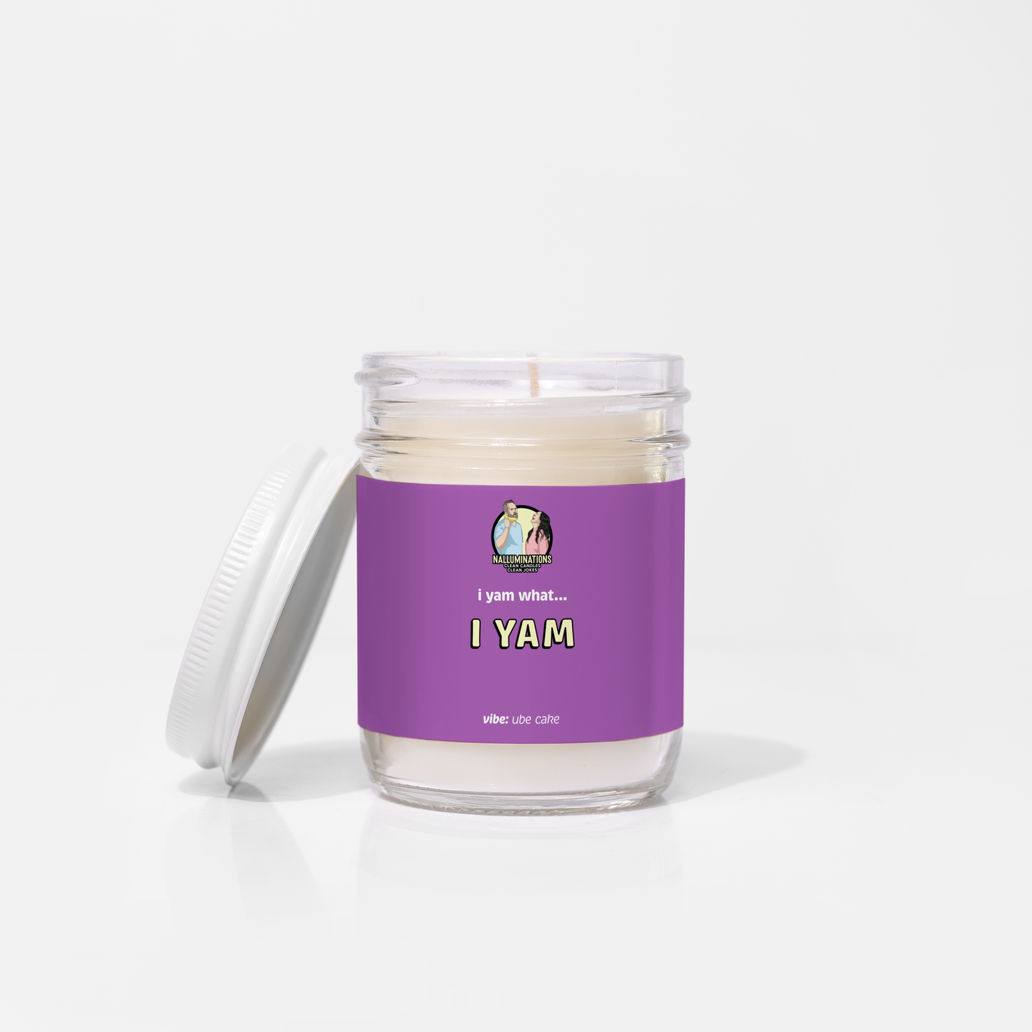 Coconut soy 6.5oz candle in a clear glass jar with white lid, labeled “I Yam” in a bold purple design with ube cake scent, unlit on a white background.
