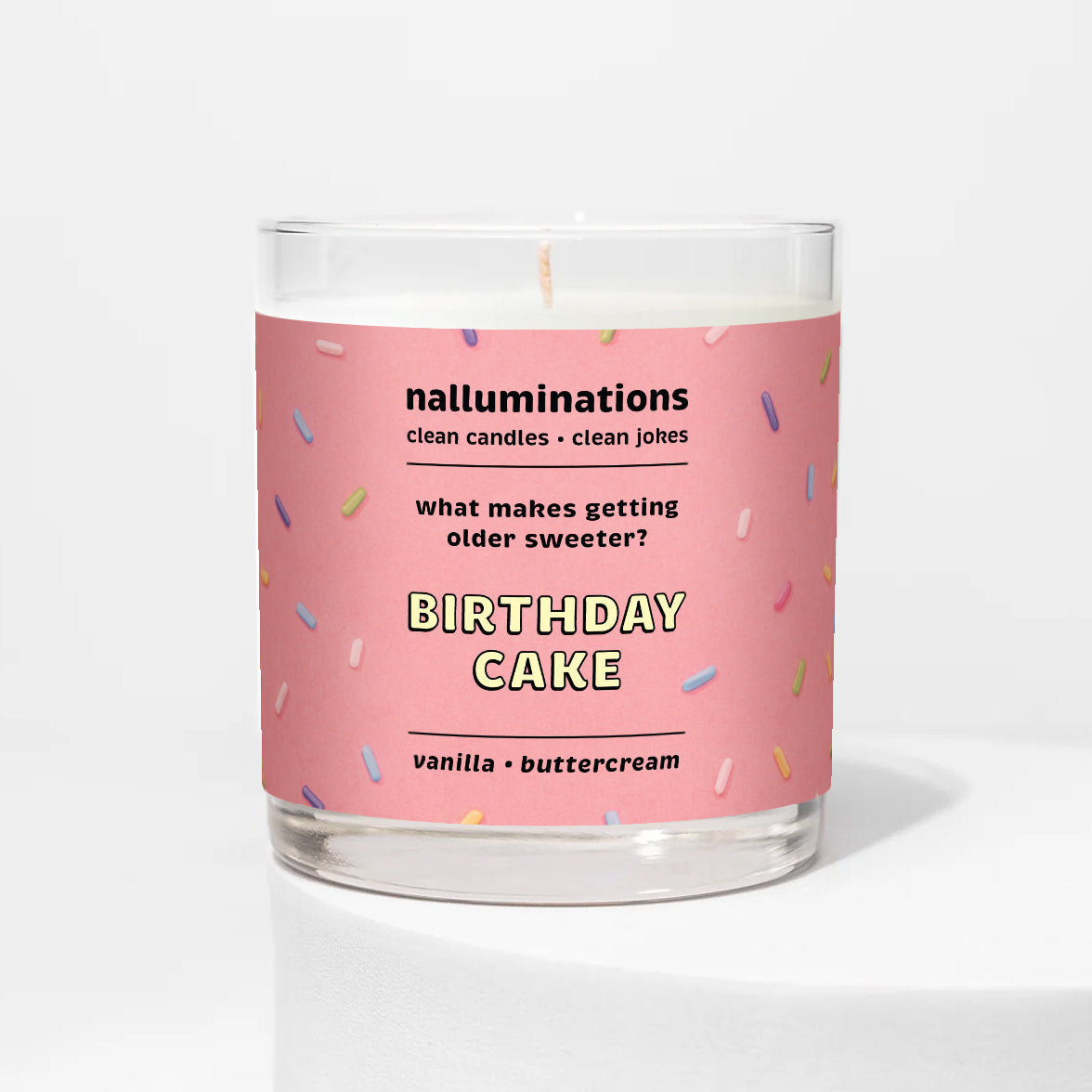 Nalluminations 8oz coconut soy candle with a pink label featuring 