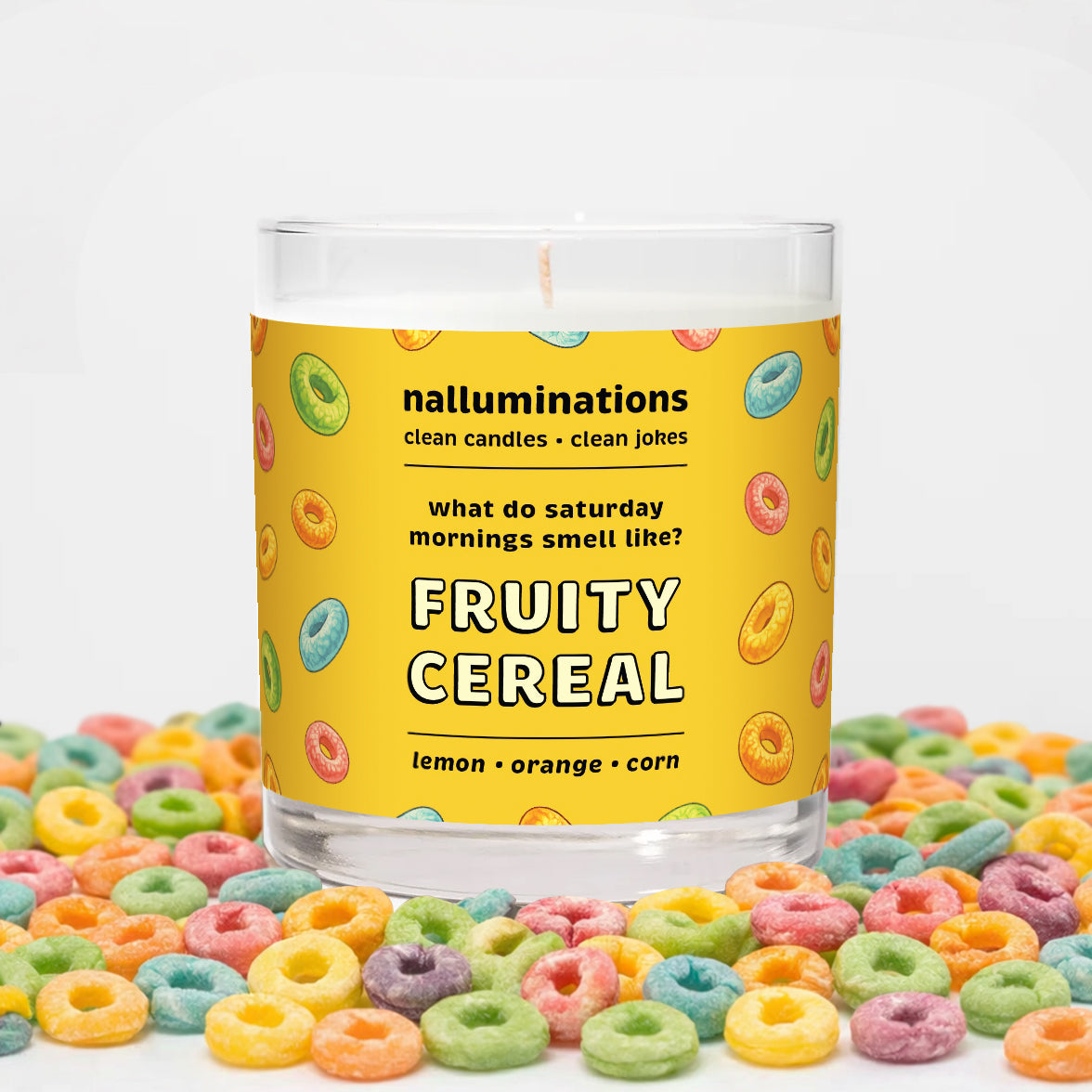 Nalluminations 8oz coconut soy candle in a clear glass label with a colorful label and text "fruity cereal" surrounded by cereal loops on a white background