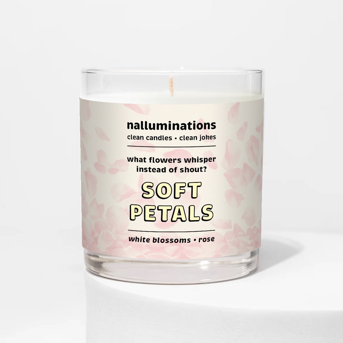 Nalluminations 8oz coconut soy candle in a clear glass vessel  with 'Soft Petals' description on a white background